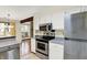 Open kitchen area with stainless steel appliances and view of the living area at 4669 Stansbury Ln, Indianapolis, IN 46254