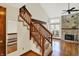 Spacious living room with a fireplace, wooden floors and a staircase at 4669 Stansbury Ln, Indianapolis, IN 46254