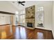 Open-concept living room features stone fireplace, vaulted ceilings, and gleaming hardwood floors at 4669 Stansbury Ln, Indianapolis, IN 46254