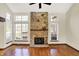 Spacious living room featuring a floor-to-ceiling stone fireplace with hearth and bright windows at 4669 Stansbury Ln, Indianapolis, IN 46254