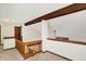 Open loft area with wood beam and railing overlooking main living space at 4669 Stansbury Ln, Indianapolis, IN 46254