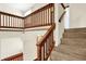Carpeted staircase with wooden railing leads to the upper level of this home at 4669 Stansbury Ln, Indianapolis, IN 46254