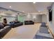 Spacious finished basement with gray sofas and neutral carpet is ready for entertaining at 6012 Yellow Birch Ct, Avon, IN 46123