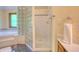 Bathroom with glass block, soaking tub, shower and wood vanity at 6012 Yellow Birch Ct, Avon, IN 46123
