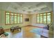 Large bonus room with tray ceiling, hardwood floors, and ample natural light at 6012 Yellow Birch Ct, Avon, IN 46123