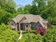 A beautiful brick home with a well-manicured lawn is surrounded by lush trees at 6012 Yellow Birch Ct, Avon, IN 46123
