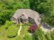 Bird's eye view of brick house surrounded by mature trees and manicured garden at 6012 Yellow Birch Ct, Avon, IN 46123