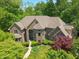 Stunning aerial view of a brick home with lush landscaping and mature trees at 6012 Yellow Birch Ct, Avon, IN 46123