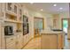 Bright kitchen featuring granite countertops, light wood cabinets, and modern appliances at 6012 Yellow Birch Ct, Avon, IN 46123
