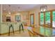 Kitchen with granite counters, wood cabinets, breakfast bar and adjacent dining area with deck access at 6012 Yellow Birch Ct, Avon, IN 46123