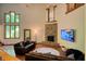 Open living room featuring high ceilings, a stone fireplace, and large windows for plenty of natural light at 6012 Yellow Birch Ct, Avon, IN 46123
