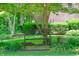 Peaceful backyard setting with a bench nestled among trees and manicured bushes at 6012 Yellow Birch Ct, Avon, IN 46123