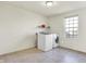 Bright laundry room featuring a window, shelving, and modern washer and dryer units at 6115 Adler Ct, Whitestown, IN 46075