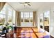 Bright sunroom featuring hardwood floors and abundant natural light from large windows at 6115 Adler Ct, Whitestown, IN 46075