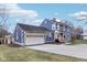 Blue house with attached garage and a spacious driveway at 635 Terrace Dr, Zionsville, IN 46077