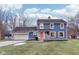 Blue house with a pink door, white trim, and attached garage at 635 Terrace Dr, Zionsville, IN 46077