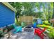 Relaxing fire pit area with colorful chairs and a wood screen at 635 Terrace Dr, Zionsville, IN 46077