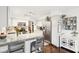 White kitchen with stainless steel appliances and breakfast bar at 635 Terrace Dr, Zionsville, IN 46077