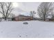 Brick house with deck and snowy backyard at 658 Mellowood Dr, Indianapolis, IN 46217