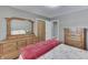 Bedroom with wooden dresser and red blanket at 658 Mellowood Dr, Indianapolis, IN 46217