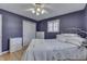 Bedroom with white bed, dresser, and purple walls at 658 Mellowood Dr, Indianapolis, IN 46217