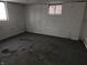 Unfinished basement with stained carpet and a single window at 821 Shellbark Rd, Anderson, IN 46011