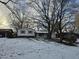 Ranch home with brick facade, visible from the street, sits on a snow-covered lot at 821 Shellbark Rd, Anderson, IN 46011