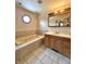 The bathroom features a built-in jacuzzi tub, vanity with mirror and octagonal window at 8662 N Kitchen Rd, Mooresville, IN 46158