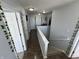 Upstairs hallway with dark hardwood floors and white doors at 8836 Hornady Ct, Indianapolis, IN 46239
