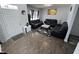 Living room with hardwood floors, black leather sectional and entry way view at 8836 Hornady Ct, Indianapolis, IN 46239