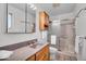 Bright bathroom features a vanity with granite countertop, tiled floors, and a shower with glass doors at 9012 Colgate St, Indianapolis, IN 46268