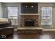 Stone fireplace with dark brown wood mantle in living room at 9238 Bainbridge Dr, Camby, IN 46113