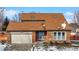 Brick house with a two-car garage and snow-covered yard at 9502 Helmsdale Dr, Indianapolis, IN 46256