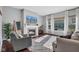 Living Room with stone fireplace, hardwood floors, and large windows at 9843 Mosaic Blue Way, Indianapolis, IN 46239