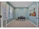 Music room with calming blue walls, carpeted floor, and built in shelving at 9843 Mosaic Blue Way, Indianapolis, IN 46239