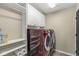 Laundry room with washer, dryer, and ample storage shelving at 9929 Brightwater Dr, Fishers, IN 46038