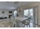 Bright dining room features a table with seating for six and a modern light fixture at 10402 Shakamak Way, Indianapolis, IN 46239