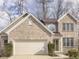 Charming brick two-story home featuring an attached two-car garage and manicured front bushes at 10402 Shakamak Way, Indianapolis, IN 46239