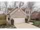 Two-story brick home with attached garage, complemented by a landscaped front yard with colorful plants at 10402 Shakamak Way, Indianapolis, IN 46239