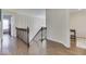 Upstairs hallway with hardwood floors and access to bedrooms at 10402 Shakamak Way, Indianapolis, IN 46239