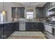 Modern kitchen with dark cabinetry and stainless steel appliances at 10402 Shakamak Way, Indianapolis, IN 46239