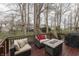 Outdoor patio furnished with cushioned seating and a table, overlooking a backyard filled with trees at 10402 Shakamak Way, Indianapolis, IN 46239