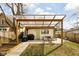 Inviting backyard patio with pergola and outdoor seating, great for relaxing and grilling at 1102 N Newman St, Indianapolis, IN 46201