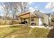Spacious backyard featuring a covered patio, lush lawn, and a charming, well-maintained home at 1102 N Newman St, Indianapolis, IN 46201