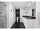 Sleek bathroom with dual sinks, modern fixtures, black and white tiling, and a glass-enclosed shower at 1102 N Newman St, Indianapolis, IN 46201