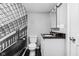 Clean, modern bathroom with stylish wallpaper, black floor tiles, and sleek fixtures at 1102 N Newman St, Indianapolis, IN 46201
