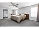 Spacious bedroom featuring a ceiling fan, a large window, and neutral decor at 1102 N Newman St, Indianapolis, IN 46201