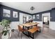 Open dining area with a wood table, bench, and modern lighting fixture at 1102 N Newman St, Indianapolis, IN 46201