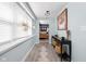 Inviting entryway with light blue walls, wooden floors, and bright natural light at 1102 N Newman St, Indianapolis, IN 46201