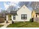 Charming home with fresh lawn, bright green door, and black trim windows at 1102 N Newman St, Indianapolis, IN 46201